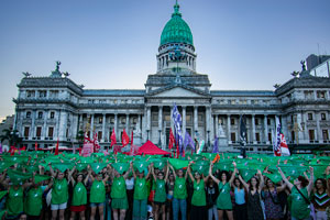 Photo of crowd of protestors wearing green